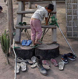 a single boot amid pairs of shoes and crutches